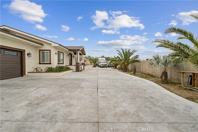 9614 Cypress Ave, Fontana, CA 92335 - view of side of property featuring driveway, fence, and stucco siding