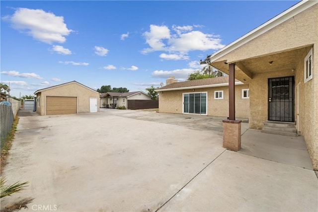9614 Cypress Ave, Fontana, CA 92335 - view of patio / terrace with fence, a detached garage, entry steps, and an outdoor structure