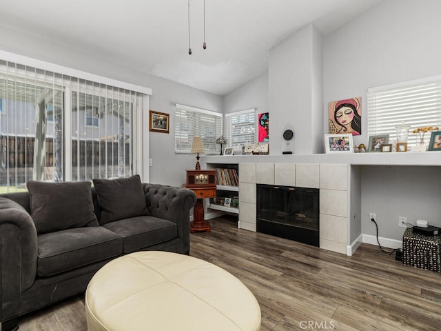 41187 Via Cedro, Murrieta, CA 92562 - living area featuring vaulted ceiling, wood finished floors, a fireplace, and baseboards