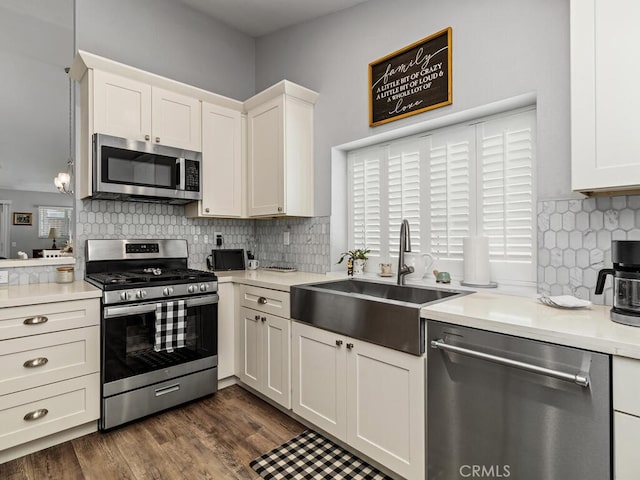 41187 Via Cedro, Murrieta, CA 92562 - kitchen with appliances with stainless steel finishes, a sink, white cabinets, light countertops, and tasteful backsplash