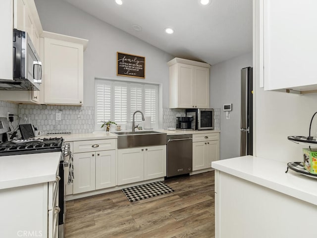 41187 Via Cedro, Murrieta, CA 92562 - kitchen featuring stainless steel appliances, a sink, tasteful backsplash, white cabinets, and light wood-style floors