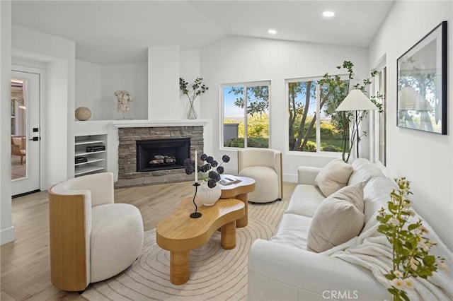7632 Penobscot Dr, West Hills, CA 91304 - living room featuring recessed lighting, vaulted ceiling, wood finished floors, and a stone fireplace