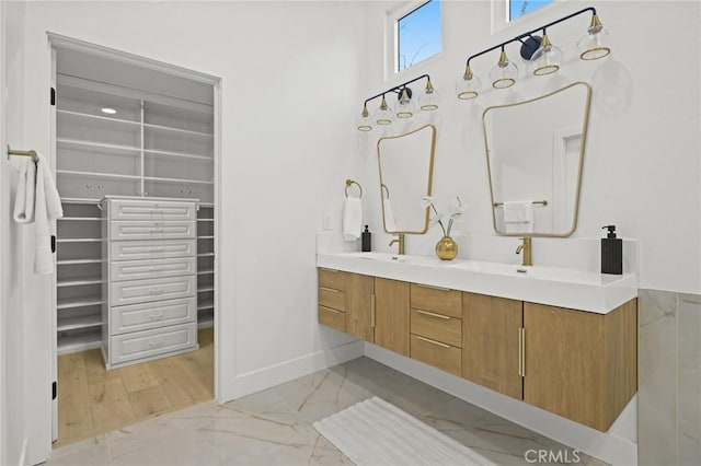 7632 Penobscot Dr, West Hills, CA 91304 - full bathroom featuring baseboards, marble finish floor, a sink, and double vanity