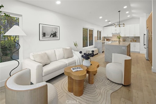 7632 Penobscot Dr, West Hills, CA 91304 - living area with recessed lighting, light wood-style floors, vaulted ceiling, and a wealth of natural light