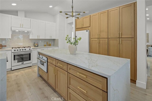7632 Penobscot Dr, West Hills, CA 91304 - kitchen with recessed lighting, under cabinet range hood, white appliances, light wood-type flooring, and a notable chandelier