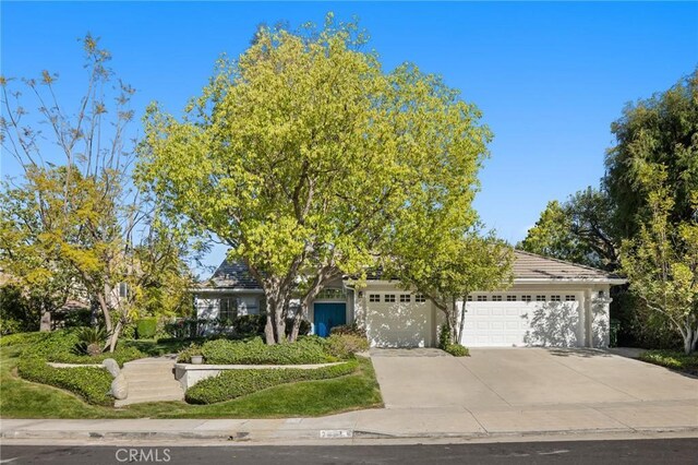 7632 Penobscot Dr, West Hills, CA 91304 - obstructed view of property with concrete driveway and an attached garage