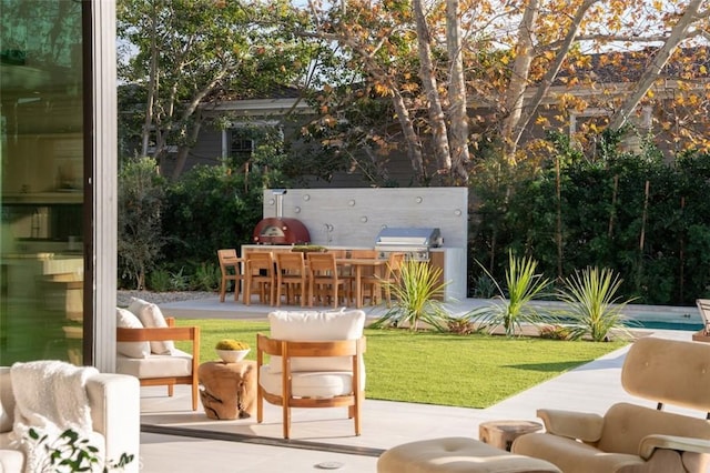 view of patio / terrace with outdoor dry bar, an outdoor kitchen, and area for grilling