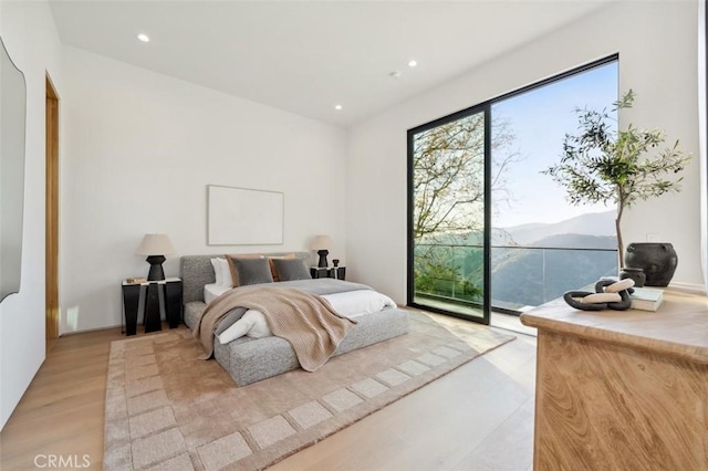 bedroom featuring recessed lighting, access to outside, and light wood-style floors