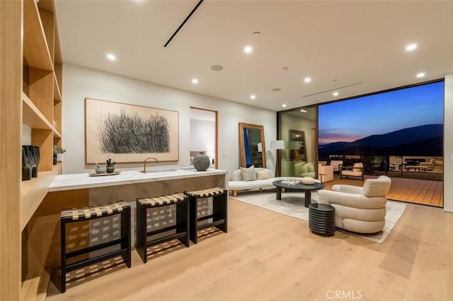 interior space featuring recessed lighting, expansive windows, and wood finished floors