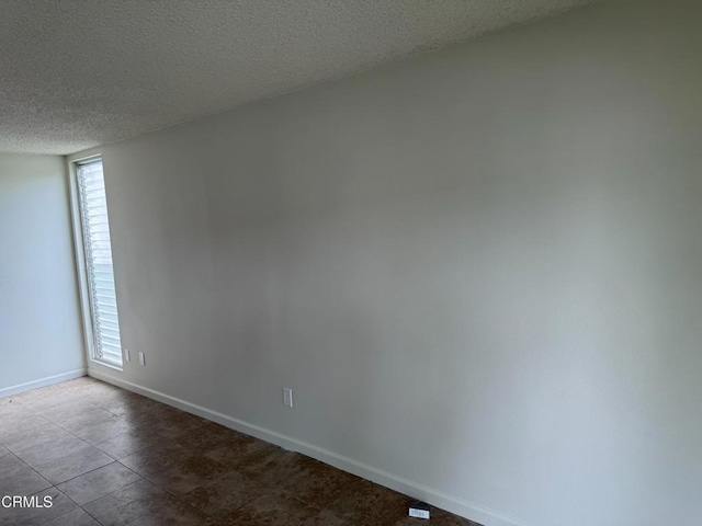 3700 Dean Dr Unit 3306, Ventura, CA 93003 - spare room featuring baseboards and a textured ceiling