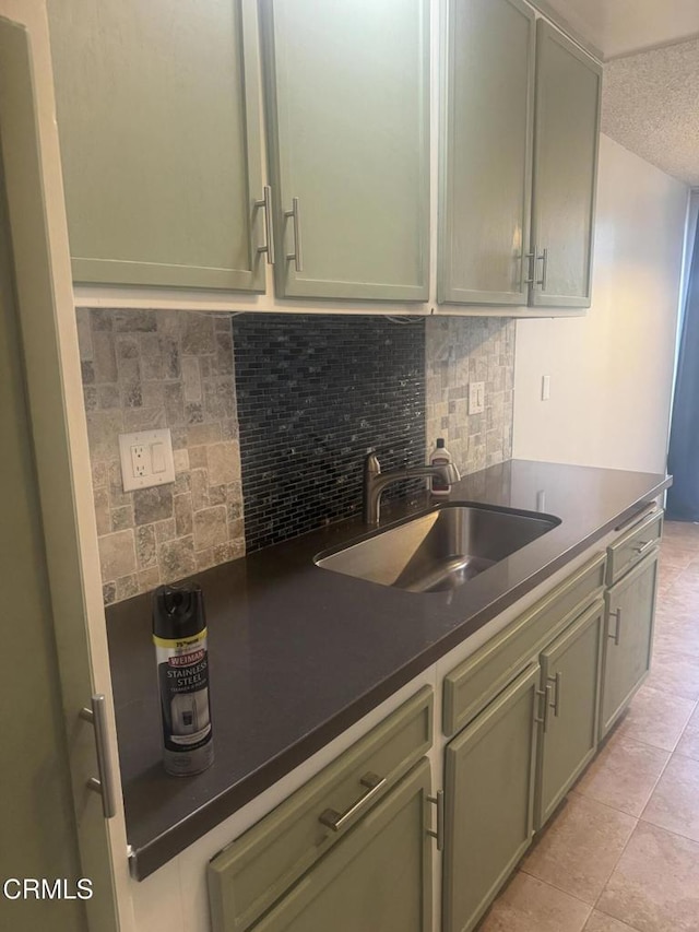 3700 Dean Dr Unit 3306, Ventura, CA 93003 - kitchen with dark countertops, light tile patterned floors, a sink, tasteful backsplash, and a textured ceiling