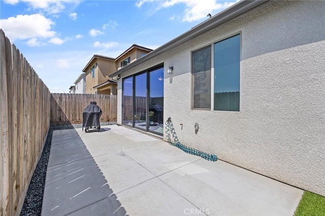 view of patio featuring a fenced backyard and a grill