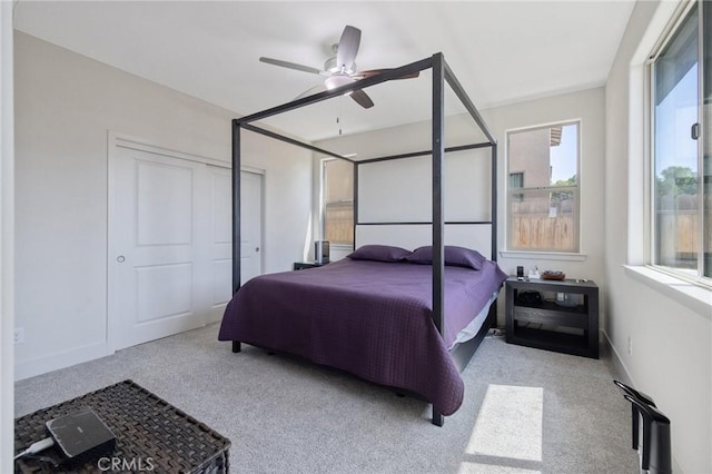 bedroom with baseboards, carpet flooring, a closet, and ceiling fan