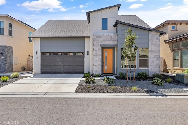 contemporary home featuring concrete driveway, an attached garage, stone siding, and a shingled roof
