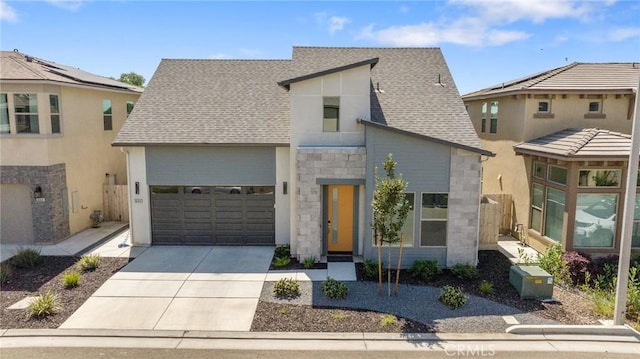 contemporary house featuring an attached garage, a shingled roof, stone siding, and concrete driveway