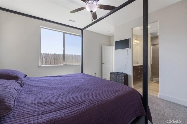 bedroom featuring carpet flooring, baseboards, visible vents, a ceiling fan, and ensuite bath