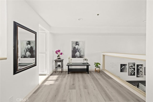 corridor with wood finished floors and baseboards