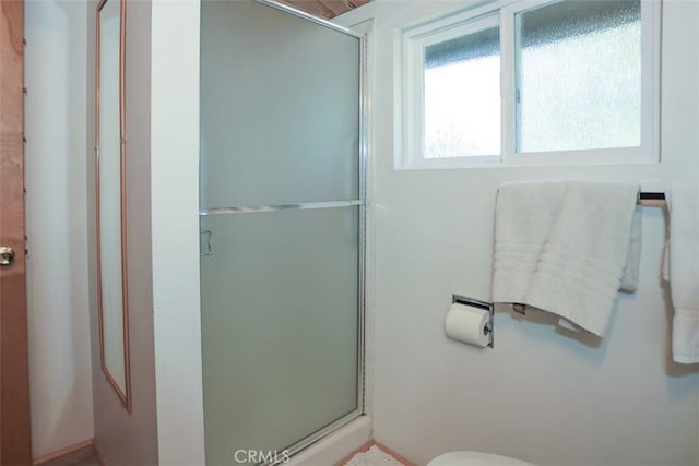 full bathroom with a shower stall and toilet