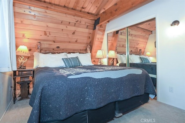 carpeted bedroom with wood ceiling, wood walls, and a closet