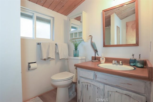 bathroom featuring wood ceiling, vaulted ceiling, vanity, and toilet