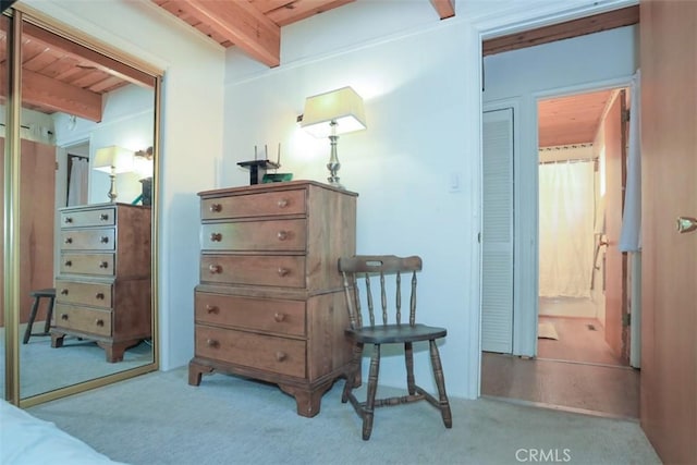 sitting room with beamed ceiling, wooden ceiling, and carpet floors