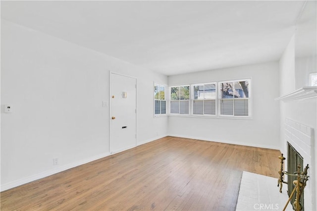 2935 Westwood Blvd, West Los Angeles, CA 90064 - unfurnished living room with baseboards, wood finished floors, and a fireplace