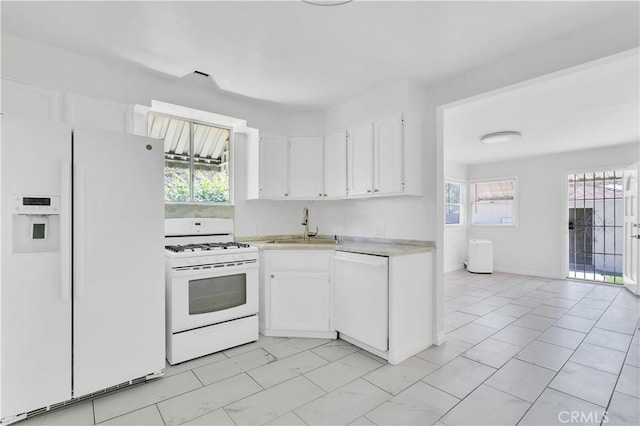 2935 Westwood Blvd, West Los Angeles, CA 90064 - kitchen with light countertops, white appliances, white cabinetry, and a healthy amount of sunlight