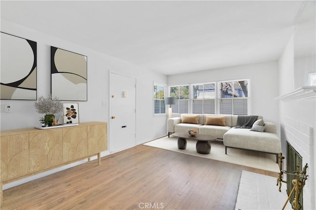 2935 Westwood Blvd, West Los Angeles, CA 90064 - living room featuring wood finished floors and a brick fireplace