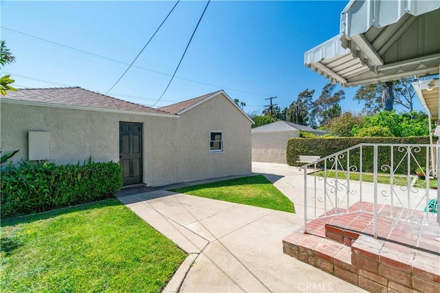2935 Westwood Blvd, West Los Angeles, CA 90064 - view of side of home featuring fence, a patio area, a shingled roof, and stucco siding