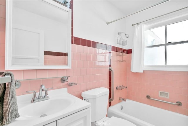 2935 Westwood Blvd, West Los Angeles, CA 90064 - bathroom with tile walls, vanity, bathtub / shower combination, and toilet
