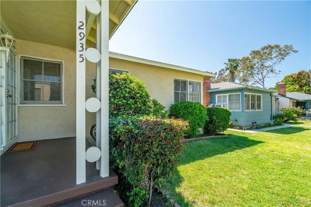 2935 Westwood Blvd, West Los Angeles, CA 90064 - view of home's exterior with a yard and stucco siding