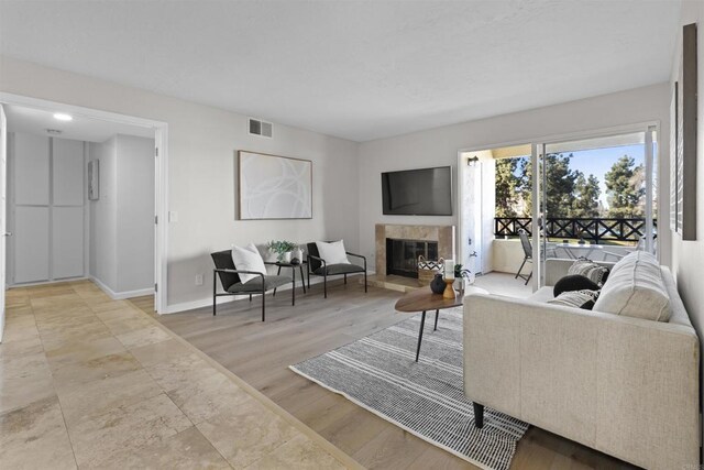 795 Brookstone Unit 201, Chula Vista, CA 91913 - living room featuring a tile fireplace and baseboards