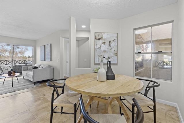795 Brookstone Unit 201, Chula Vista, CA 91913 - dining area featuring baseboards and a textured ceiling