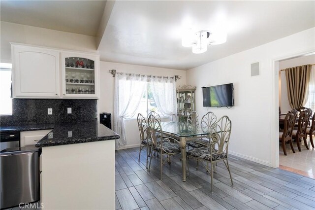 dining room with baseboards, a notable chandelier, visible vents, and wood tiled floor