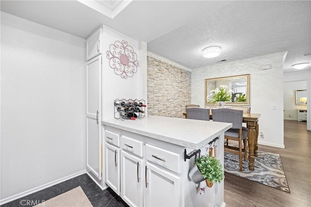 5879 Portsmouth Rd Unit 250, Yorba Linda, CA 92887 - kitchen with white cabinets, light countertops, dark wood-style flooring, and crown molding