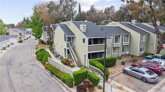 5879 Portsmouth Rd Unit 250, Yorba Linda, CA 92887 - view of property featuring uncovered parking, a residential view, and stairs