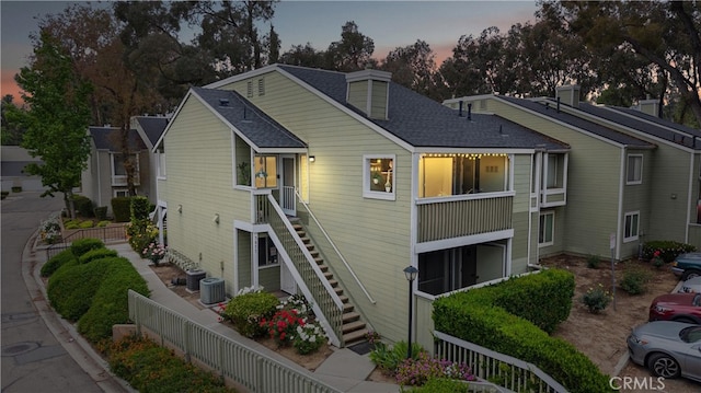 5879 Portsmouth Rd Unit 250, Yorba Linda, CA 92887 - view of front of house featuring a fenced backyard, roof with shingles, and stairs