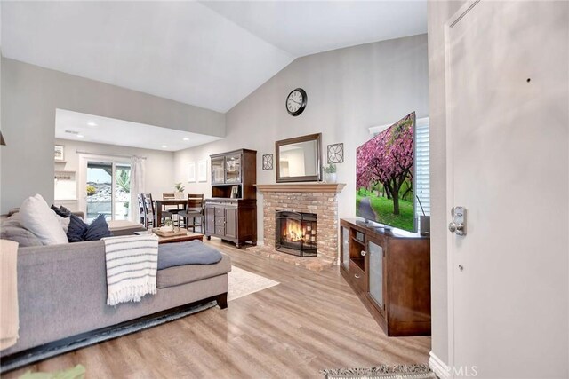 10830 Sundance Dr, Rancho Cucamonga, CA 91730 - living room with lofted ceiling, wood finished floors, and a fireplace