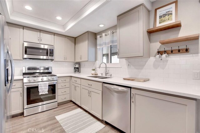 10830 Sundance Dr, Rancho Cucamonga, CA 91730 - kitchen with light wood-style flooring, appliances with stainless steel finishes, decorative backsplash, and a sink