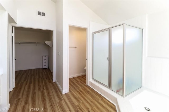 8288 Mercury Dr, Buena Park, CA 90620 - full bathroom featuring a shower stall, a spacious closet, wood finished floors, toilet, and lofted ceiling