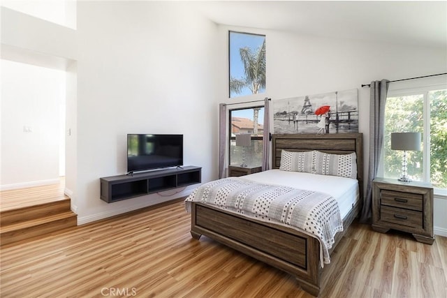 8288 Mercury Dr, Buena Park, CA 90620 - bedroom featuring light wood-style flooring, high vaulted ceiling, and baseboards