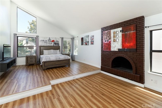 8288 Mercury Dr, Buena Park, CA 90620 - bedroom with wood finished floors, baseboards, a brick fireplace, and high vaulted ceiling