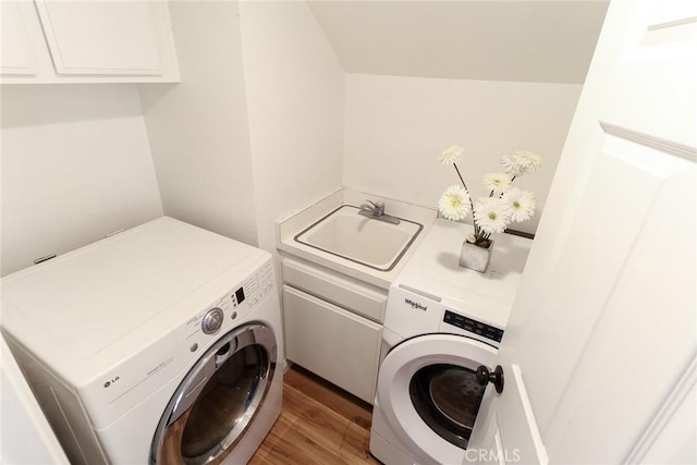 8288 Mercury Dr, Buena Park, CA 90620 - laundry room with cabinet space, light wood-style flooring, and washing machine and dryer