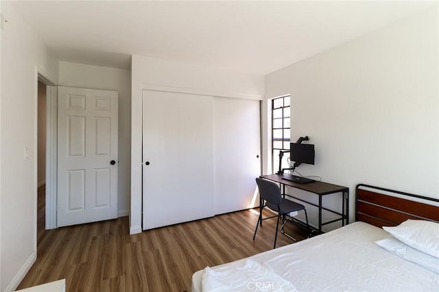 8288 Mercury Dr, Buena Park, CA 90620 - bedroom featuring wood finished floors, a closet, and baseboards