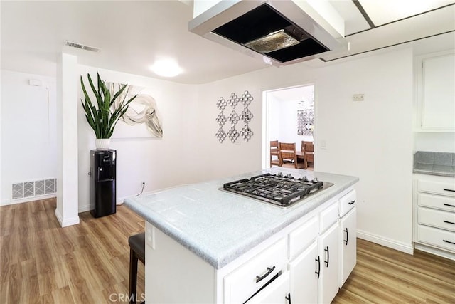 8288 Mercury Dr, Buena Park, CA 90620 - kitchen featuring stainless steel gas stovetop, ventilation hood, light wood-type flooring, and light countertops