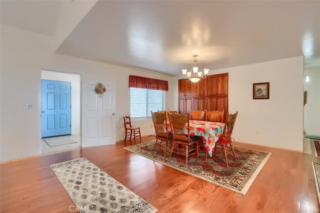 dining space featuring a chandelier and light wood-style floors