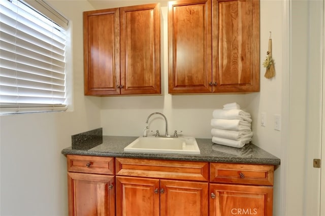 laundry area with a wealth of natural light and a sink