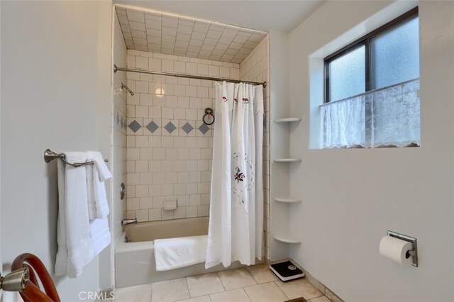 full bath featuring tile patterned floors and shower / tub combo
