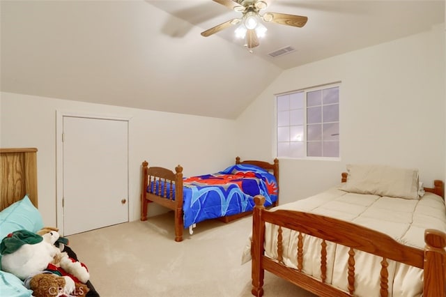 bedroom featuring lofted ceiling, visible vents, a ceiling fan, and carpet floors