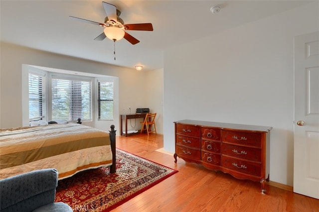 bedroom with a ceiling fan and light wood-type flooring